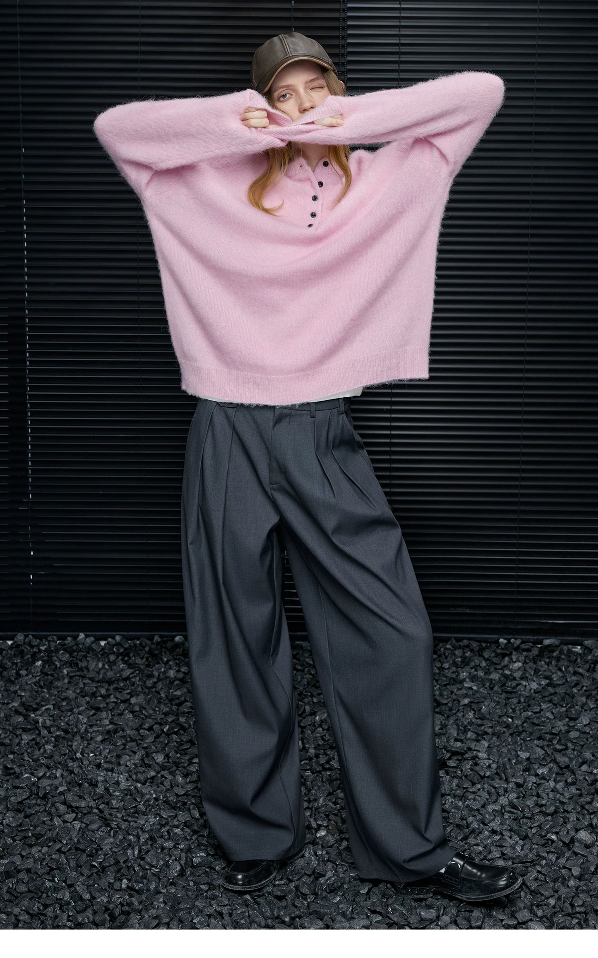Full-length look of Baby Pink alpaca-wool Henley sweater with a brown leather cap and black loafers