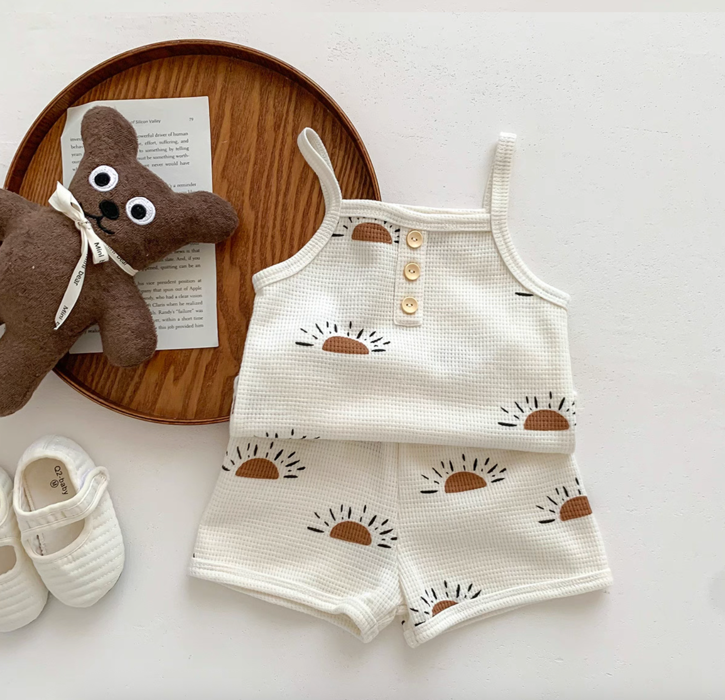Three baby waffle knit camisole tops in sunshine, woodland, and stone prints