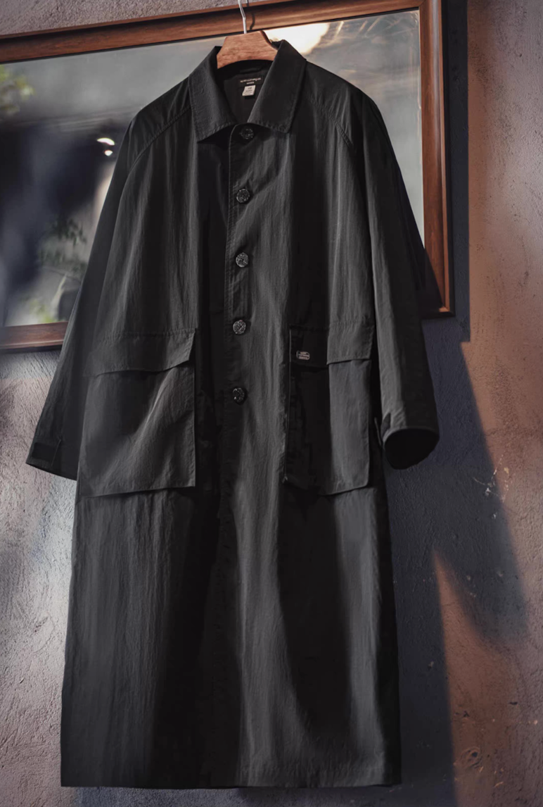 balmacaan overcoat hanging on a rack showing button front