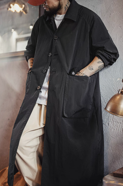 model wearing balmacaan overcoat with hands in pockets
