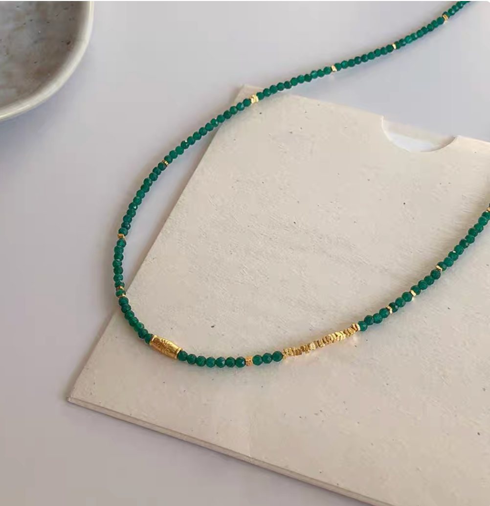 Barcelona Green Agate Choker with green agate beads and gold plated accents on neutral display surface