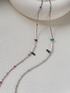 Baroque Elegance Layered Necklace featuring turquoise and garnet accents with baroque pearl and silver chain displayed together