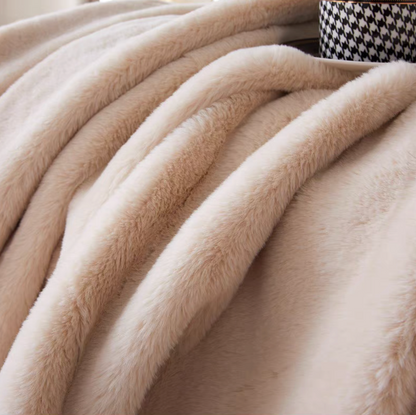 Close-up of beige plush faux fur throw blanket showing ultra soft and fluffy texture