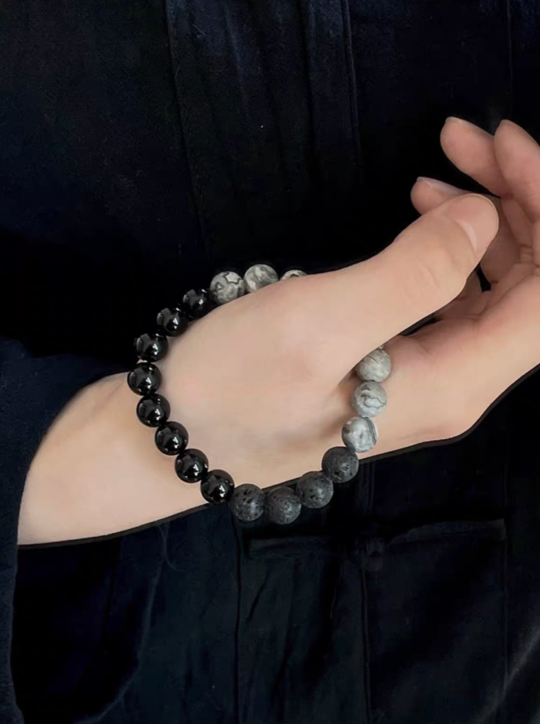 Close-up of Black Beach Onyx Volcanic Stone Bracelet worn on wrist showing black onyx, volcanic stone and gray map stone beads