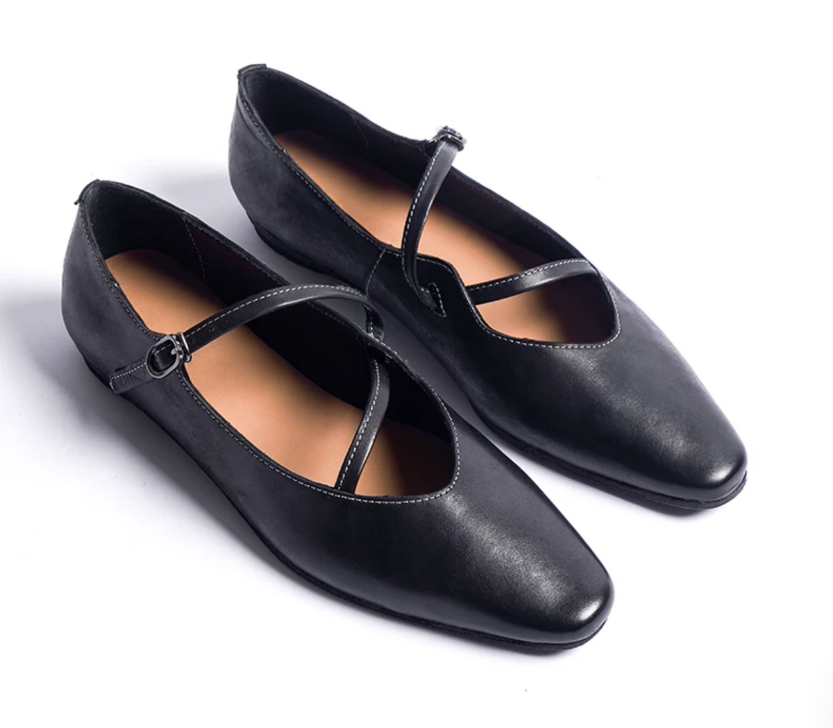 Pair of Black washed leather ballet flats with looping straps and gunmetal buckles