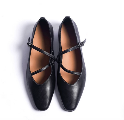 Top-down view of Black leather ballet flats with crisscross straps and white contrast stitching