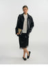 Full-length view of a black faux leather jacket falling to the hip