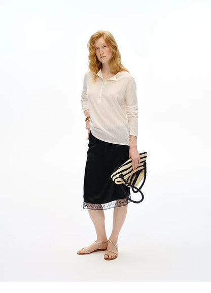 Full-length view of Black satin midi skirt with floral lace hem