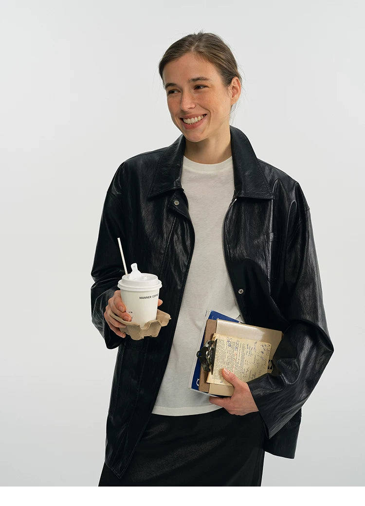 Black relaxed faux leather jacket worn open with dropped shoulders, front view