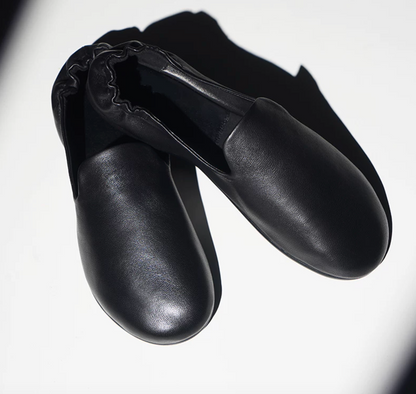 Front view of Black lambskin slipper loafers with soft round toes and clean vamps