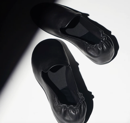 Overhead view of Black slipper loafers showing the gathered elastic heel collars
