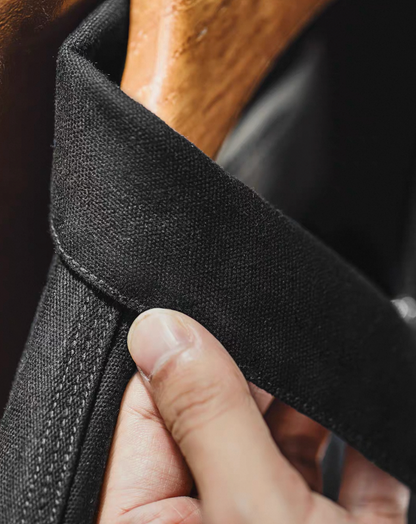 Close-up of collar detail on black cotton workwear jacket