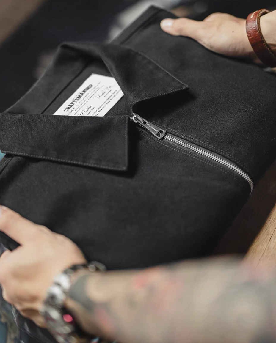 Folded black cotton workwear jacket with zipper detail