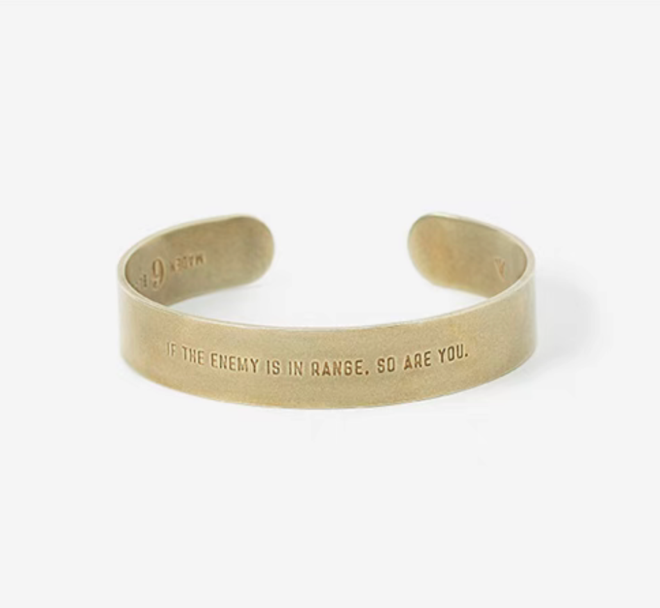 Bliss battlefield-inspired brass cuff bracelet in natural color showing engraved message on front in product view