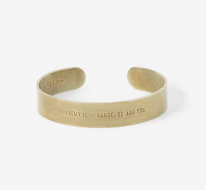 Bliss battlefield-inspired brass cuff bracelet in natural color showing engraved message on front in product view