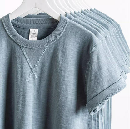 Blue Mist Crew Neck Tee blue color multiple shirts hanging on rack showing sleeve and neckline detail