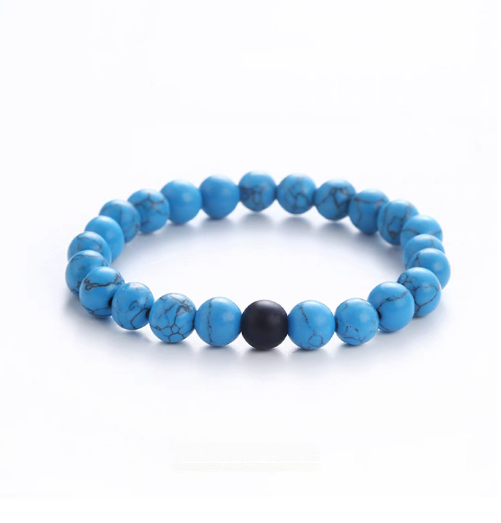 Blue turquoise minimal bead bracelet with natural veining and a single matte black accent bead