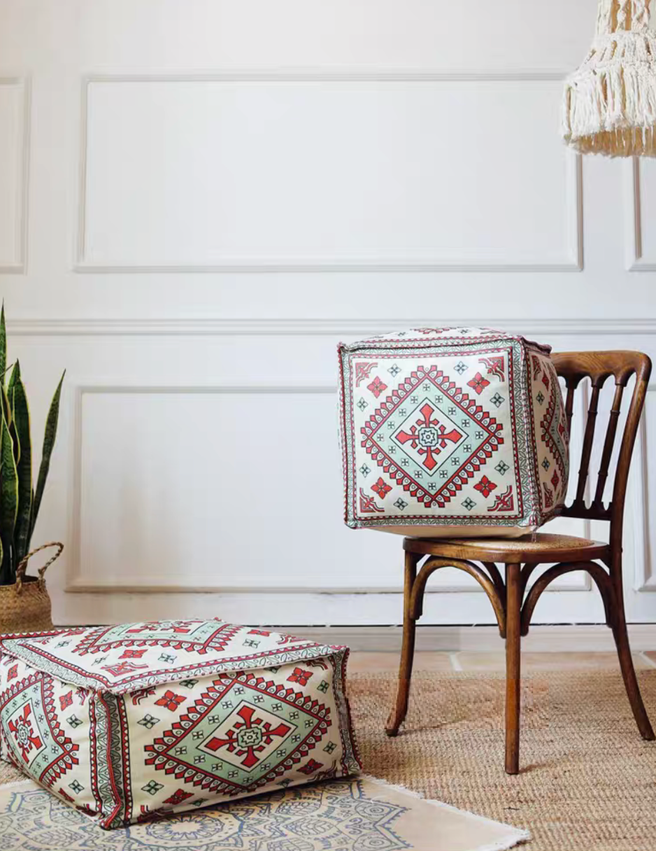 Vinnie Yellow bohemian patterned square floor pouf cushion displayed on and beside a wooden chair