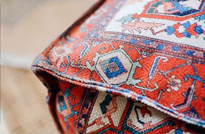 Close-up of Persian Red bohemian patterned square floor pouf cushion fabric and corner detail