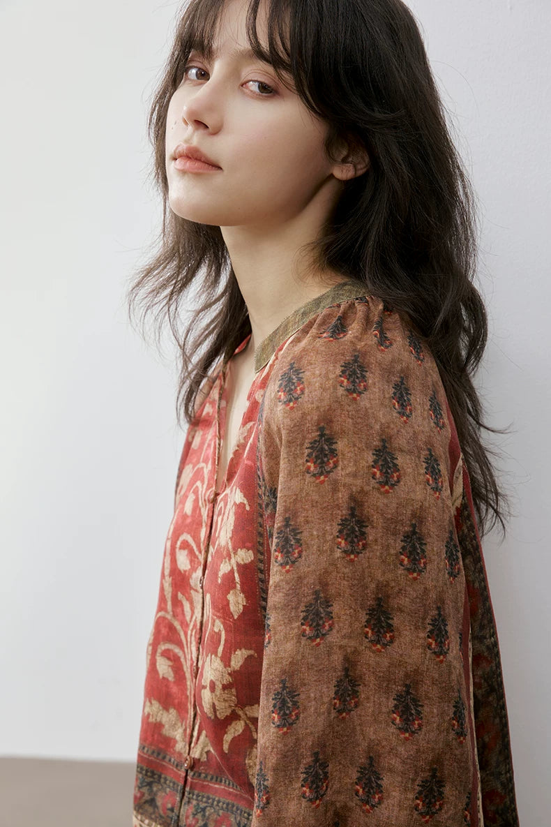 Close-up of rust floral print blouse collar and sleeve print detail