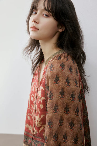 Close-up of rust floral print blouse collar and sleeve print detail