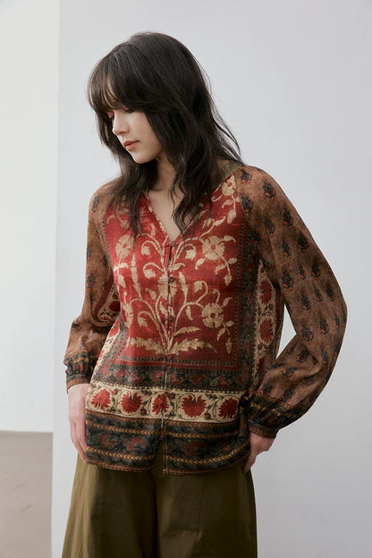 Close-up of rust floral print blouse showing V-neck and button placket