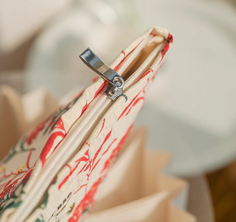 Detailed view of Botanical Embroidered Zip Makeup Pouch in red floral embroidery highlighting zipper and stitching
