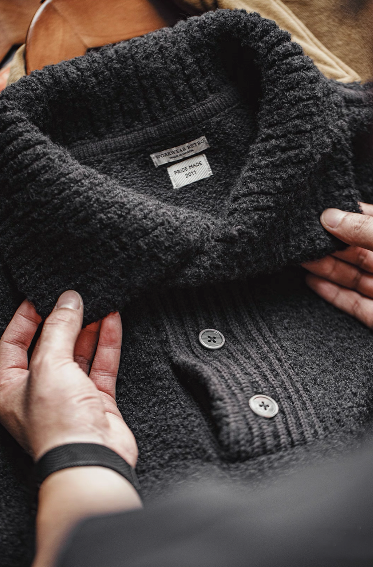 Close-up of ribbed collar and button placket of Black Bouclé Polo Sweater