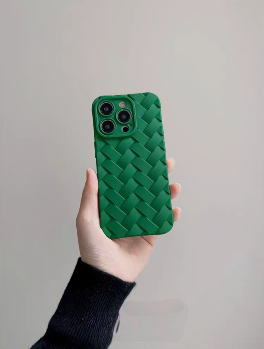 Green braided silicone phone case held in hand showing detailed woven texture and camera protection