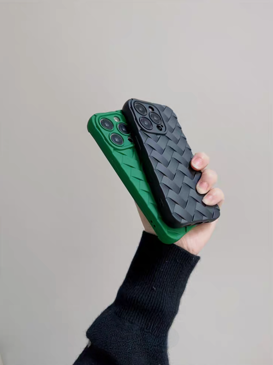 Black and green braided silicone phone cases held at an angle highlighting textured woven design and slim profile