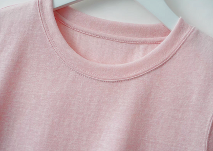 Close-up of Breeze Sheer Classic Tee in pink featuring crewneck stitching and soft slub jersey fabric texture