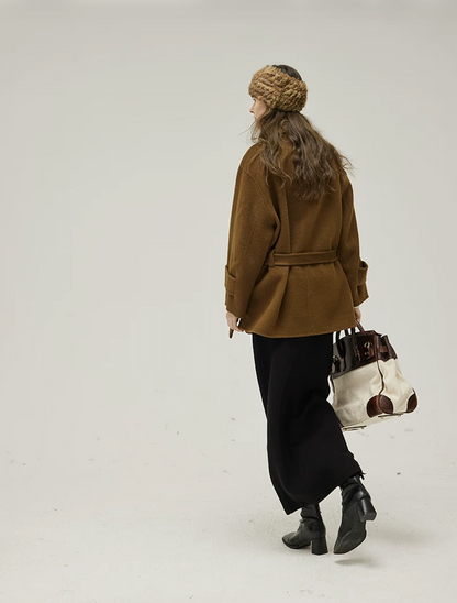 Back view of a Brown short wool coat with belt through back loops and dropped shoulders