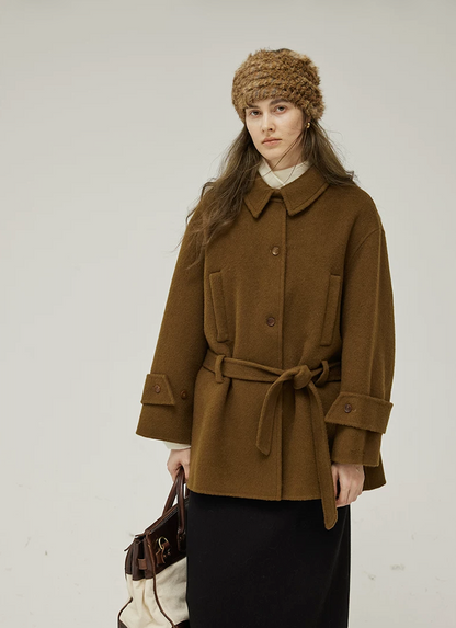 Brown double-face wool coat belted at the waist, with two vertical welt pockets