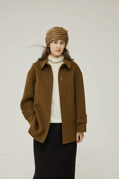 Front view of a Brown double-face wool coat with point collar, button front, and buttoned cuff tabs