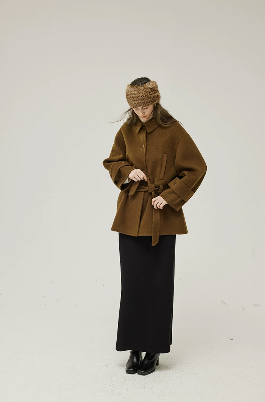 Brown short wool coat buttoned and tied at the waist with its self-fabric belt