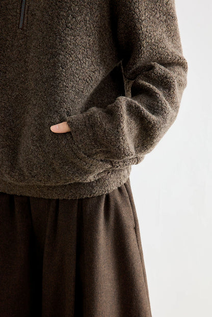 Brown bouclé wool pullover, close-up of side pocket and cuff detail