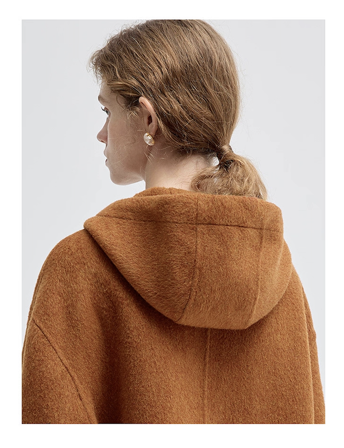 Close-up of the brown hooded coat back, focusing on the hood and shoulder seam details.