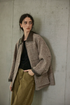 Brown speckled wool tweed field jacket worn open, with leather-look collar and rolled leather-look cuffs