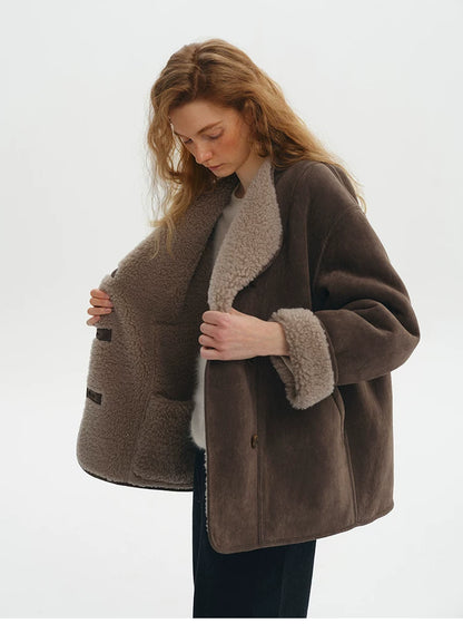 Brown faux-shearling jacket held open to show the taupe wool reverse side and button tabs