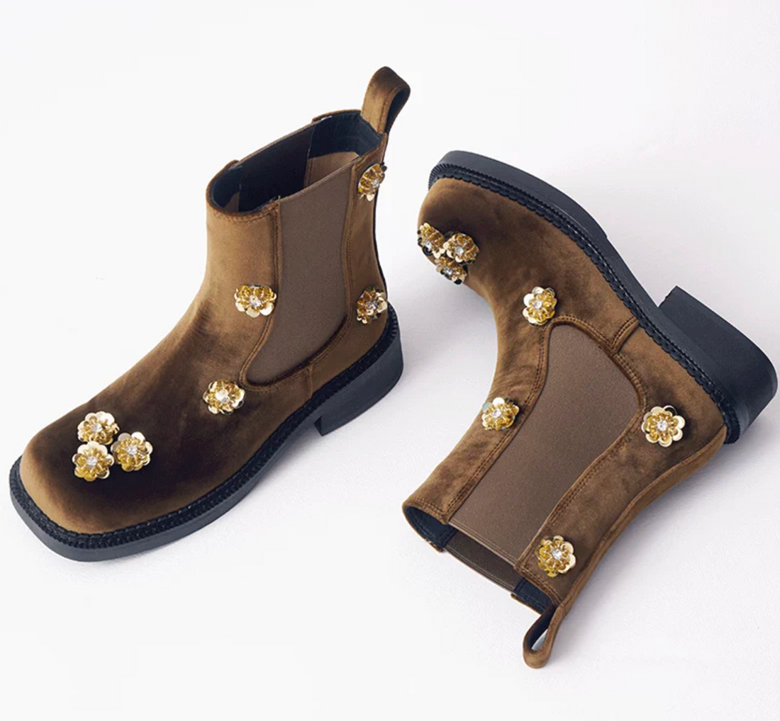Top view of brown velvet Chelsea boots with gold sequin flowers and a square toe