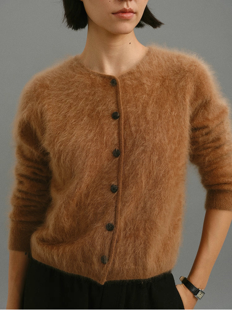 Close-up of caramel brushed cashmere cardigan showing fuzzy texture and button closure.