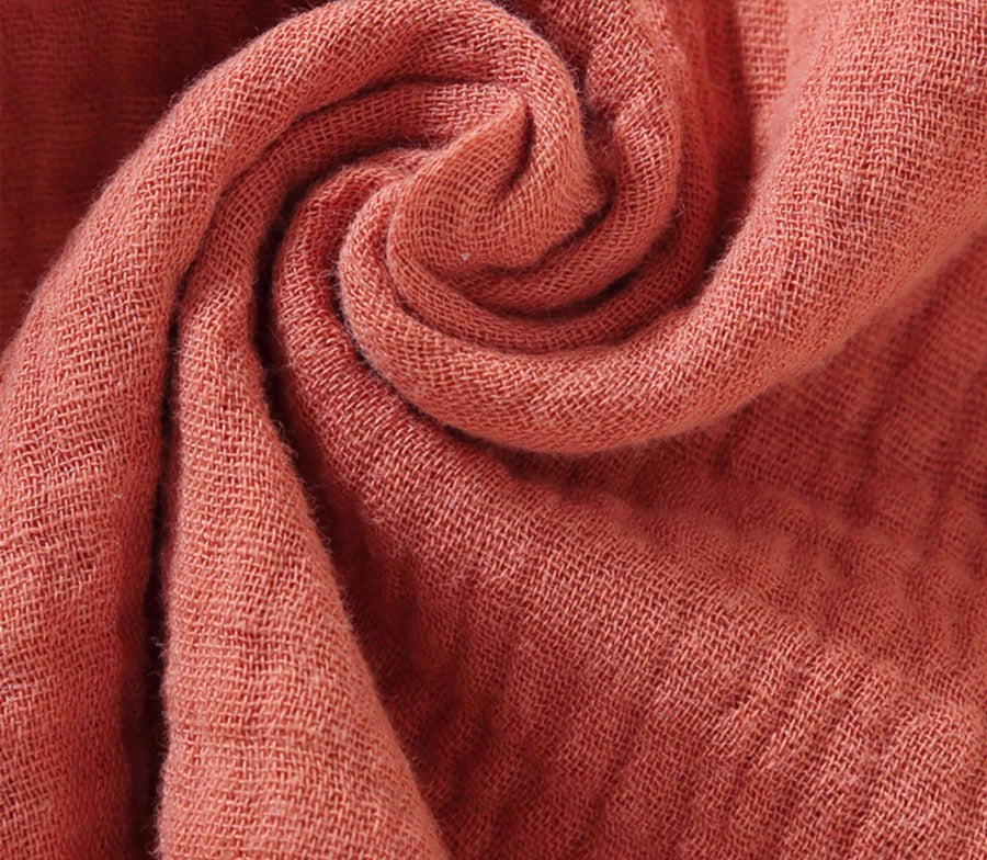 Close-up of orange bunny lovey teething toy muslin cotton fabric texture