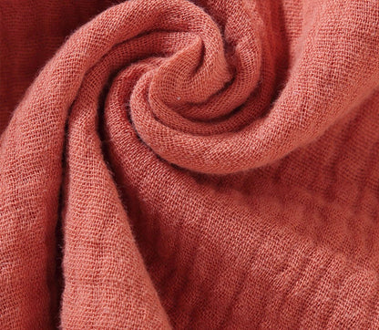 Close-up of orange bunny lovey teething toy muslin cotton fabric texture