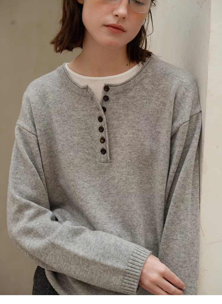 Close-up of light gray Buttoned Henley Knit Pullover Sweater showing half-button placket and knit texture