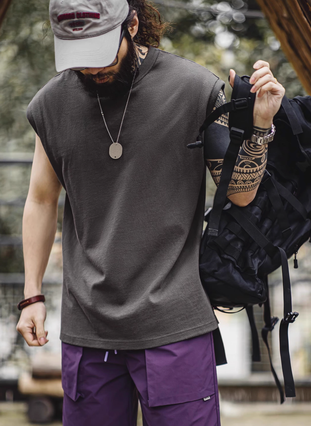 California Chill Tank Meteorite Gray worn lifestyle view with backpack showing relaxed fit and casual street style