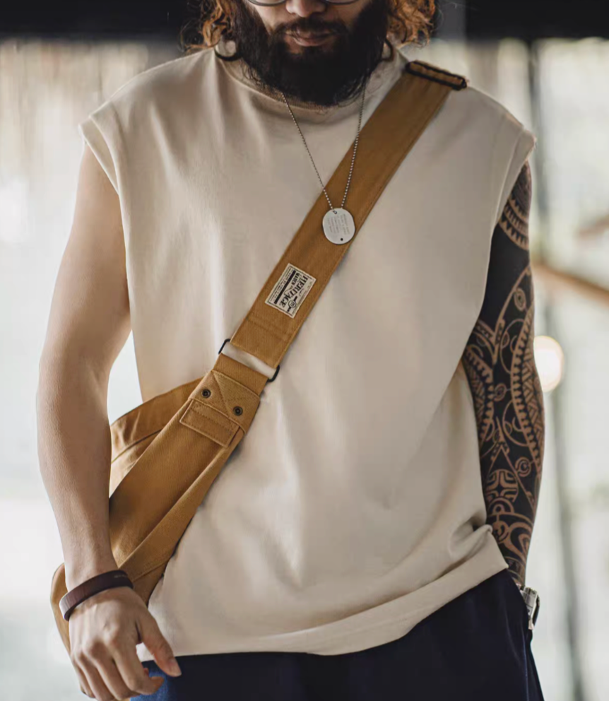 California Chill Tank White worn lifestyle view with crossbody bag showing relaxed fit and clean sleeveless design