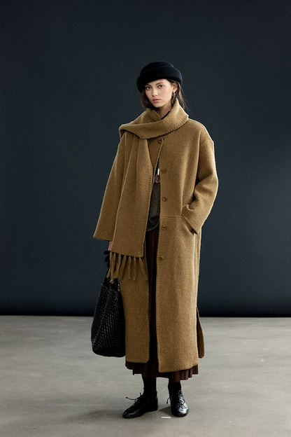 Front view of a Camel mid-calf wool coat buttoned, with the matching fringed scarf draped at the neck