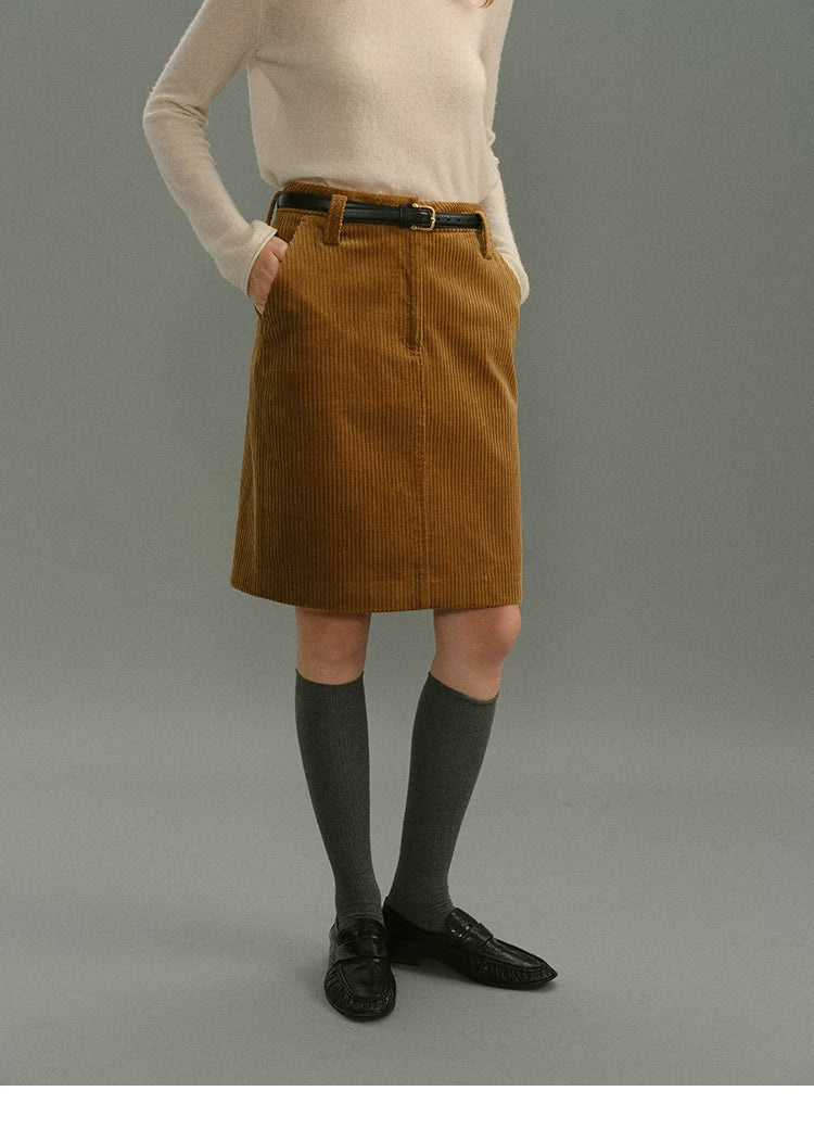Front close-up of a camel corduroy skirt with zip fly, belt loops, and side pockets