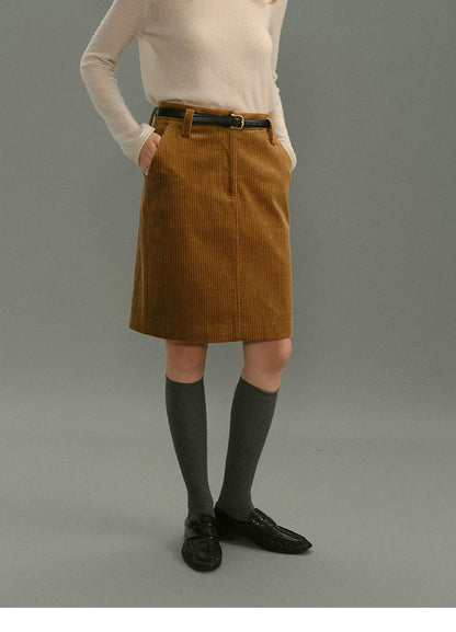 Front close-up of a camel corduroy skirt with zip fly, belt loops, and side pockets