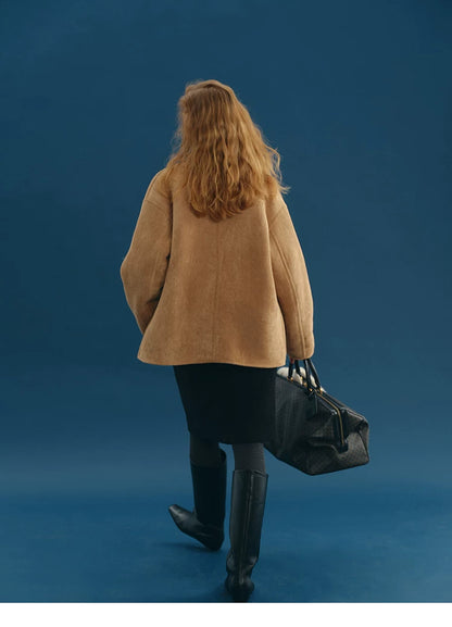Back view of a Camel faux-shearling jacket showing the boxy hip-length cut
